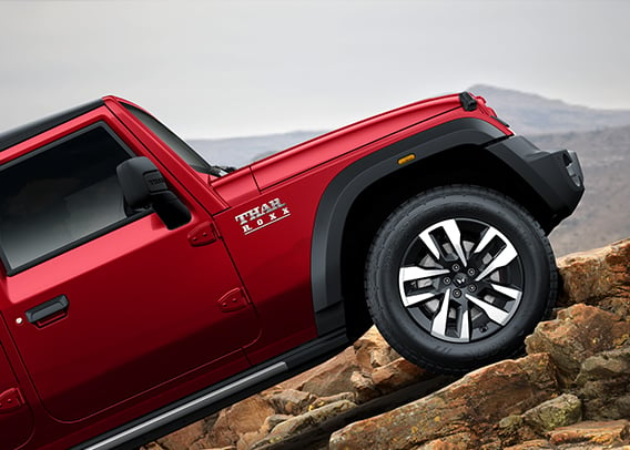 a red truck on a rocky hill