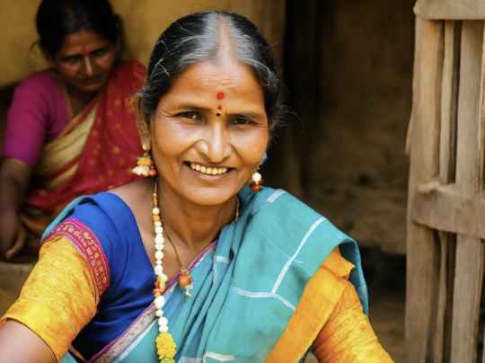 a woman in a colorful sari smiling