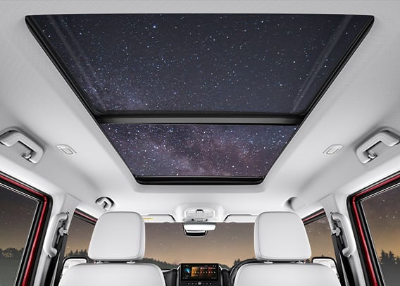 a car with a skylight and stars in the sky